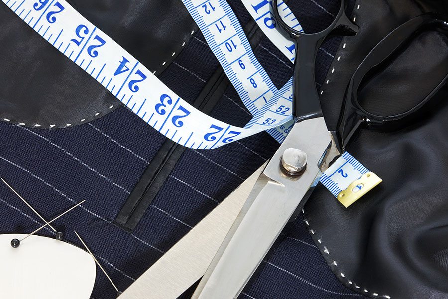 Professional Tailoring Tools Including Tape Measure, Scissors, Needles, and Thread